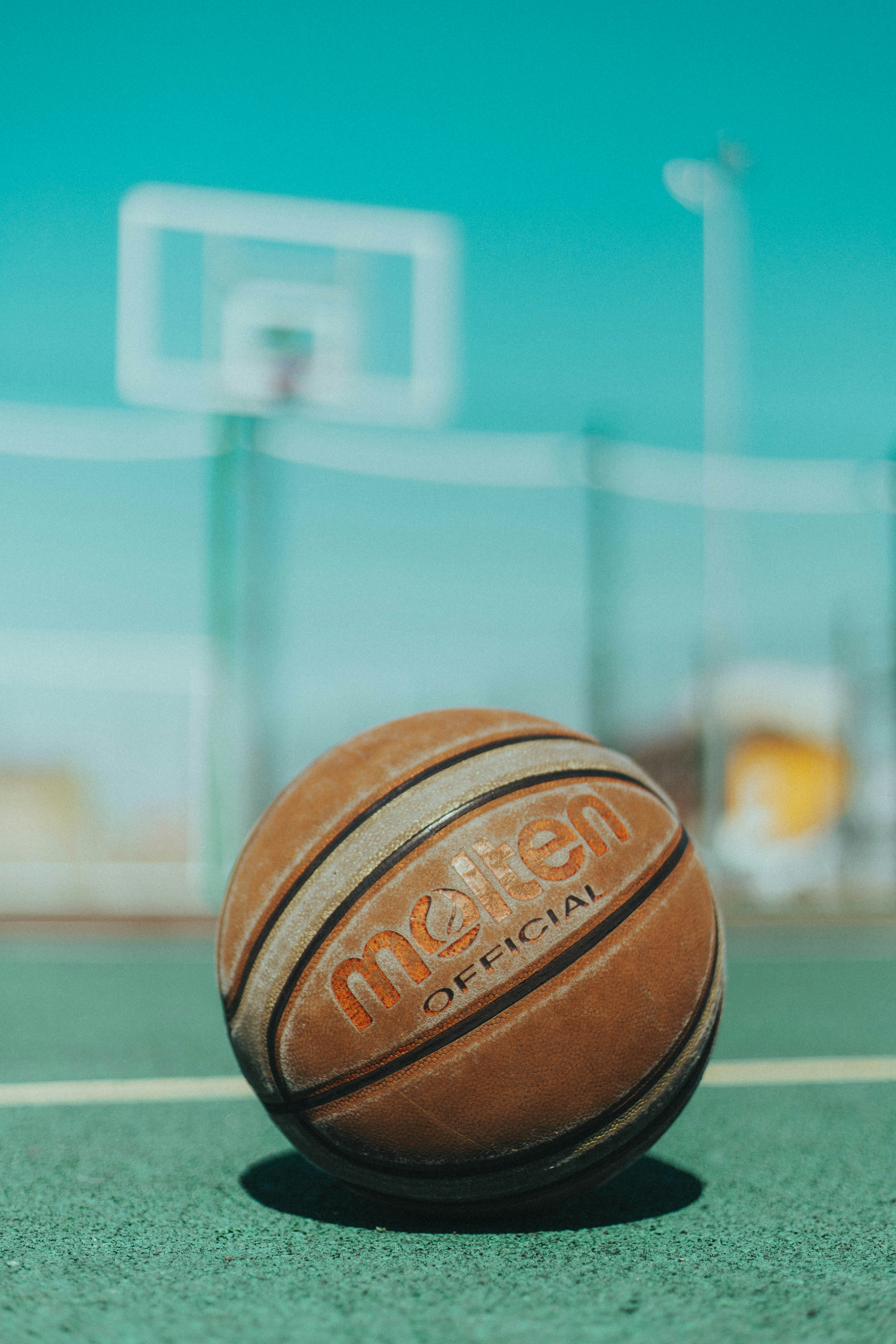 brown basketball on green surface